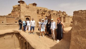 Tourists at a historical Moroccan kasbah on a 5 days tour from Marrakech