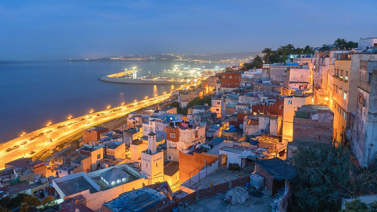 Tangier at dusk; city lights and coastline glowing